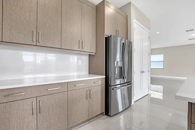 a kitchen with stainless steel appliances granite countertop a refrigerator and a sink
