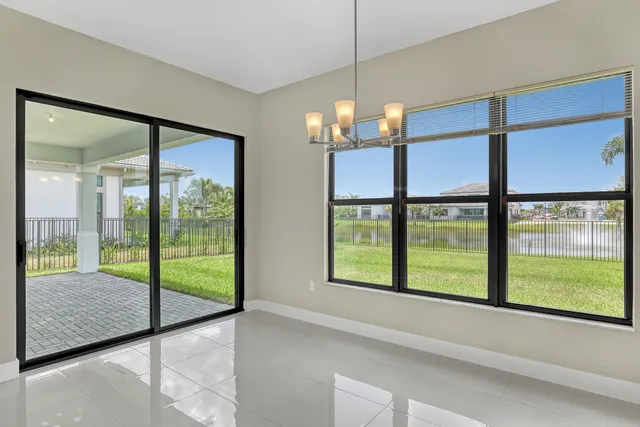 a view of a room with a large window and bed