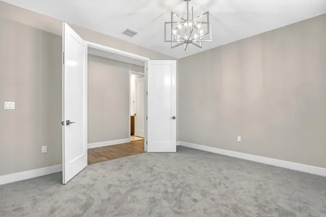 a view of an empty room with a chandelier