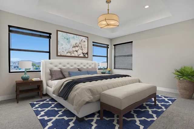 a bedroom with a large bed and a chandelier