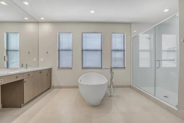 a bathroom with a double vanity sink and a bathtub
