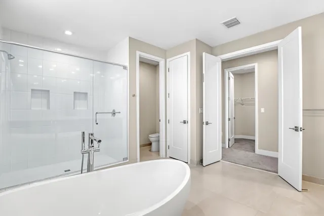 a bathroom with a tub shower and sink