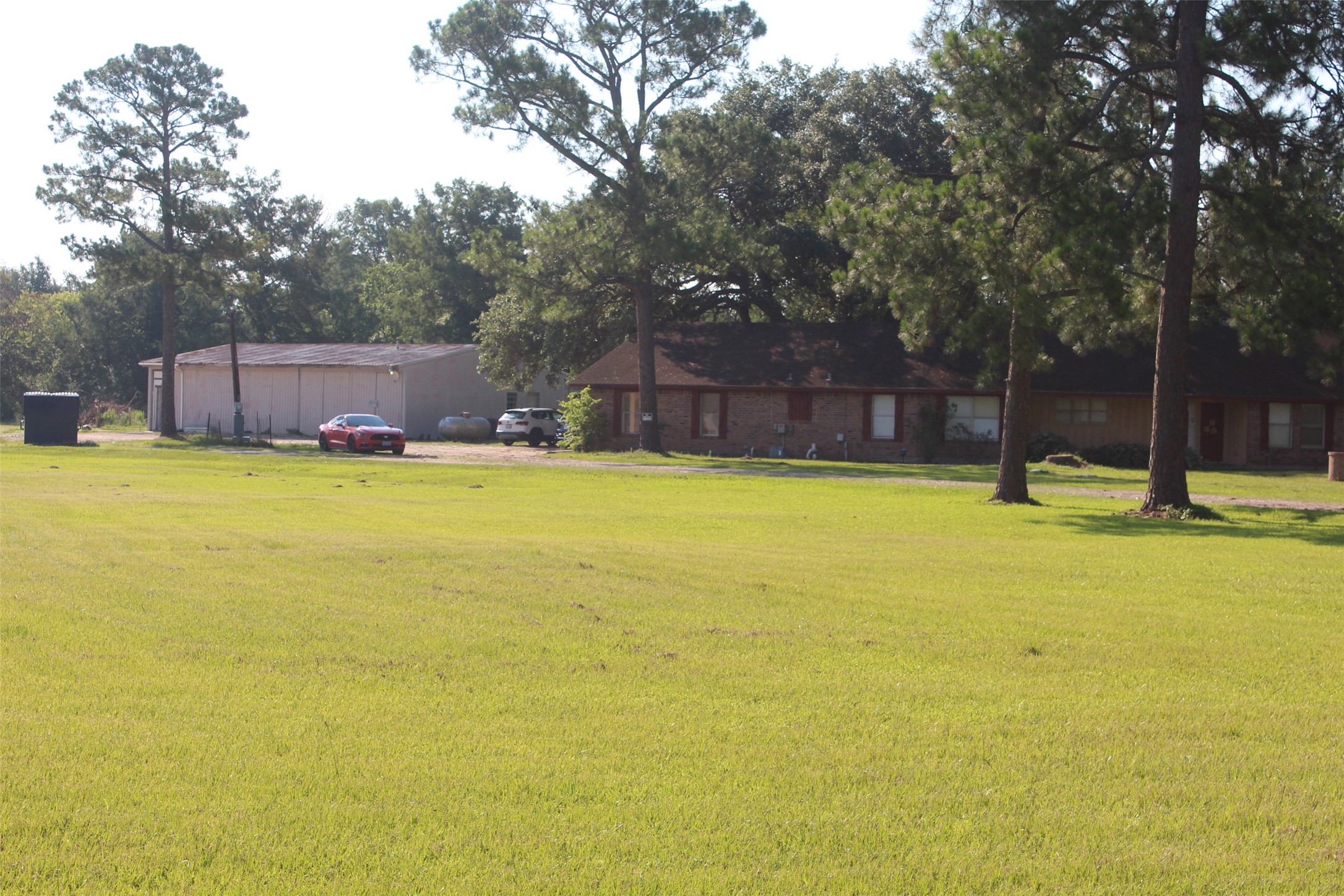 4531 Curry Street Manvel, TX 77578 - Photo 9 of 24 a swimming pool with trees in front of it