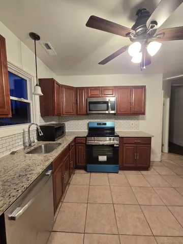 a kitchen with stainless steel appliances granite countertop a sink counter space cabinets and a counter space