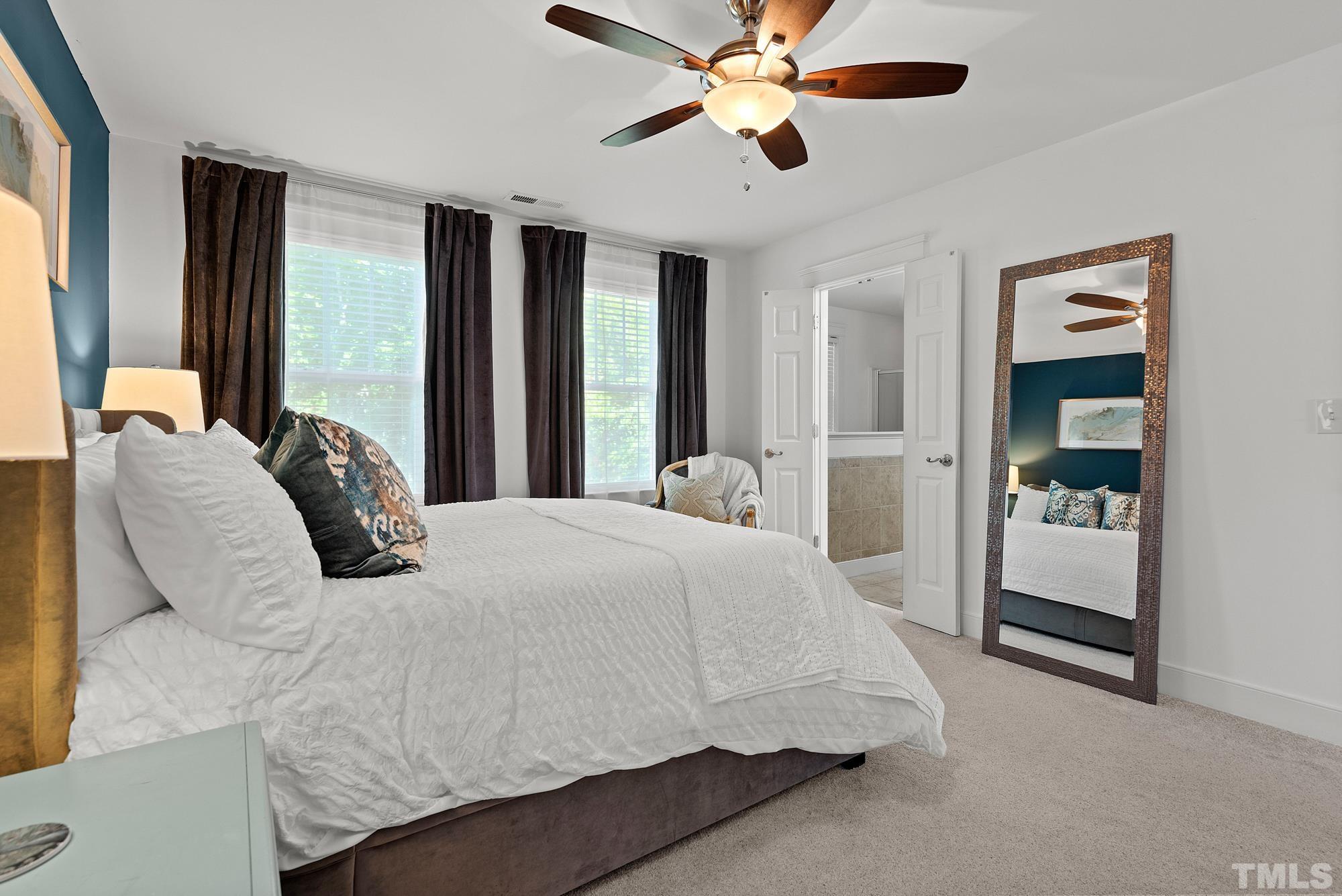 4413 All Points View Way Raleigh, NC 27614 - Photo 22 of 51 a bedroom with a large bed and a chandelier