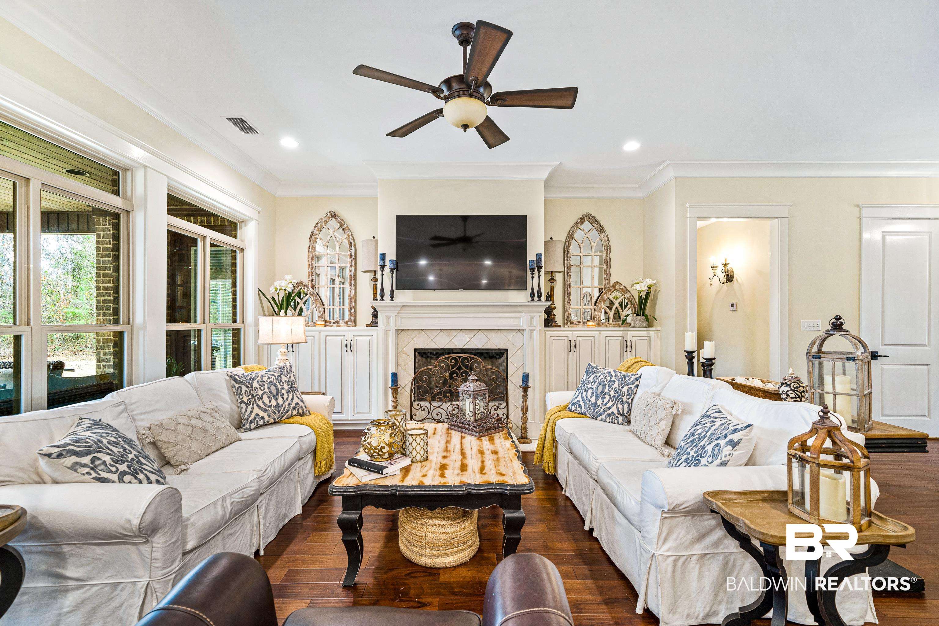 36784 Legacy Way Bay Minette, AL 36507 - Photo 10 of 57 Living room featuring dark wood-type flooring, crown molding, and a tile fireplace
