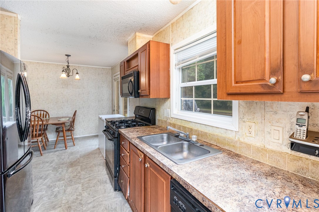 1292 Mt Prospect Road Laneview, VA 22504 - Photo 7 of 25 a kitchen with granite countertop a sink and a stove
