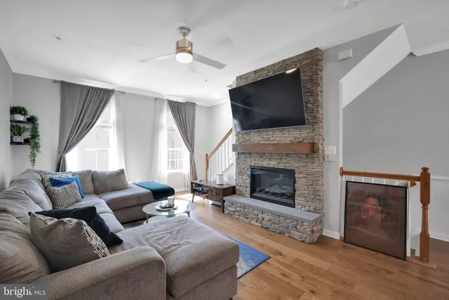 a living room with furniture fireplace and flat screen tv