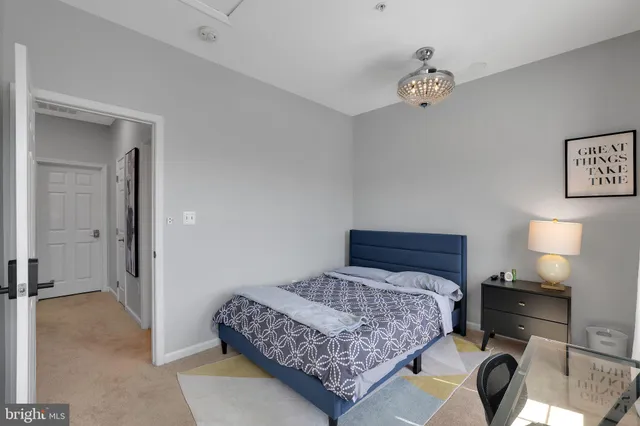 a bedroom with a bed and a lamp