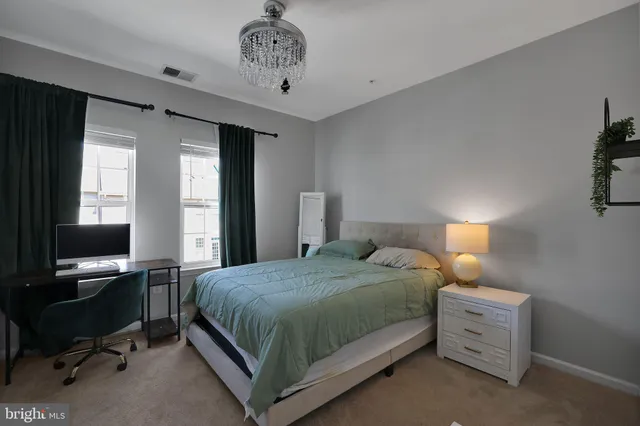 a bedroom with a bed and a desk