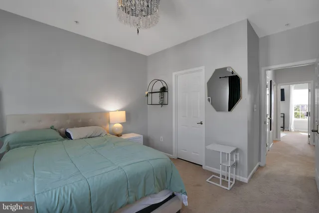 a bedroom with a bed and a mirror