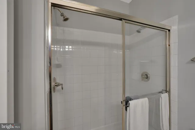 a bathroom with a glass shower door