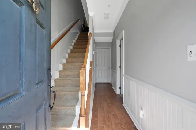 a view of a hallway with wooden floor and entryway