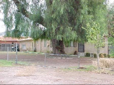 10620 Victoria Avenue Riverside, CA 92503 - Photo 1 of 1 a front view of a house with a yard and a garage