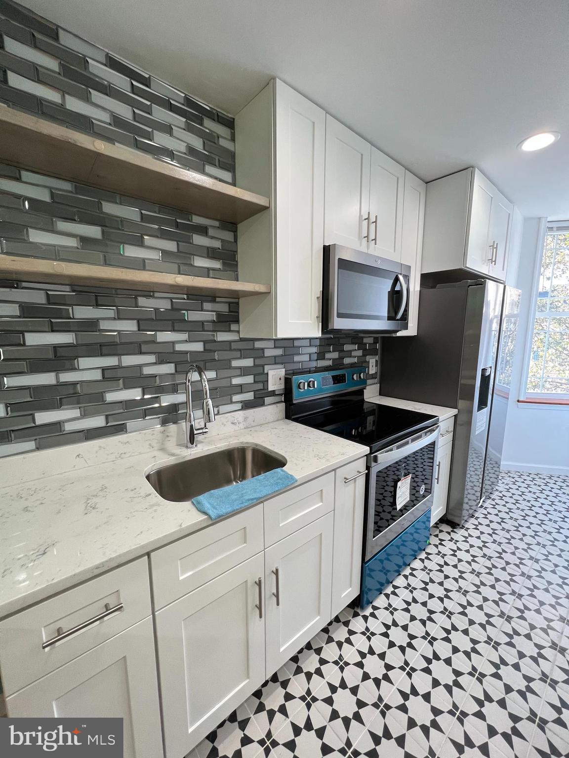 a kitchen with a sink cabinets and appliances
