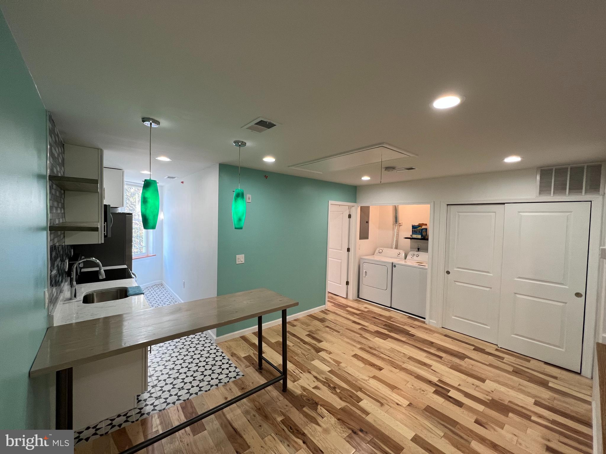 623 South 4th Street, Unit 3 Philadelphia, PA 19147 - Photo 4 of 11 a open kitchen with kitchen island white cabinets and stainless steel appliances