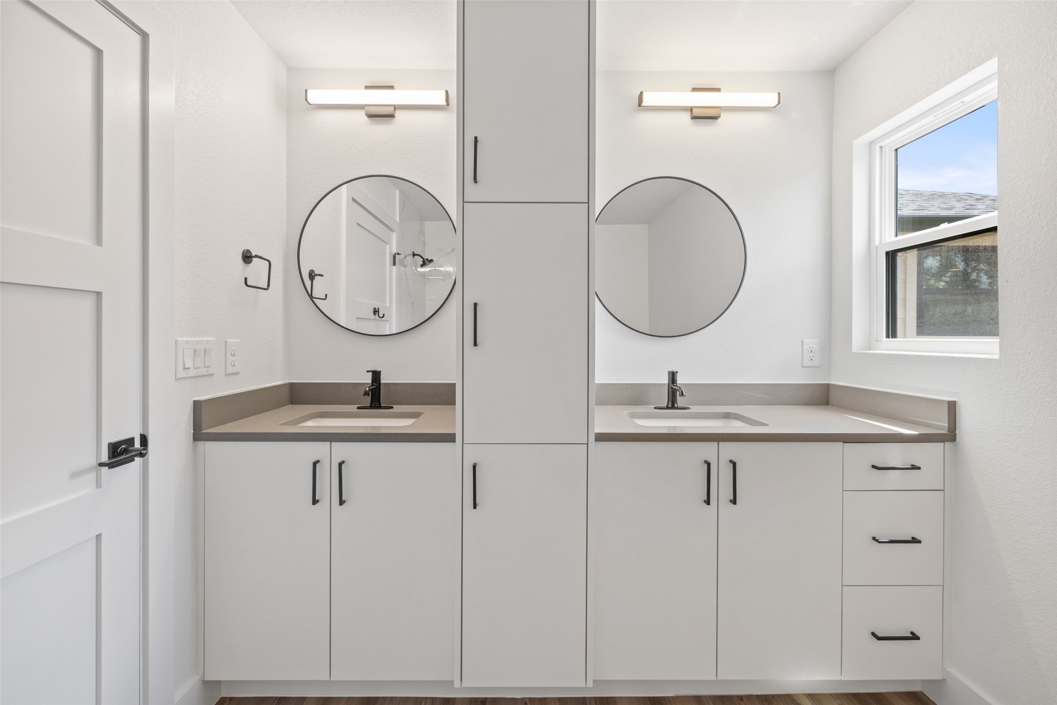 11151 Highway 71 Spicewood, TX 78669 - Photo 11 of 38 a bathroom with a granite countertop double vanity sink and a mirror
