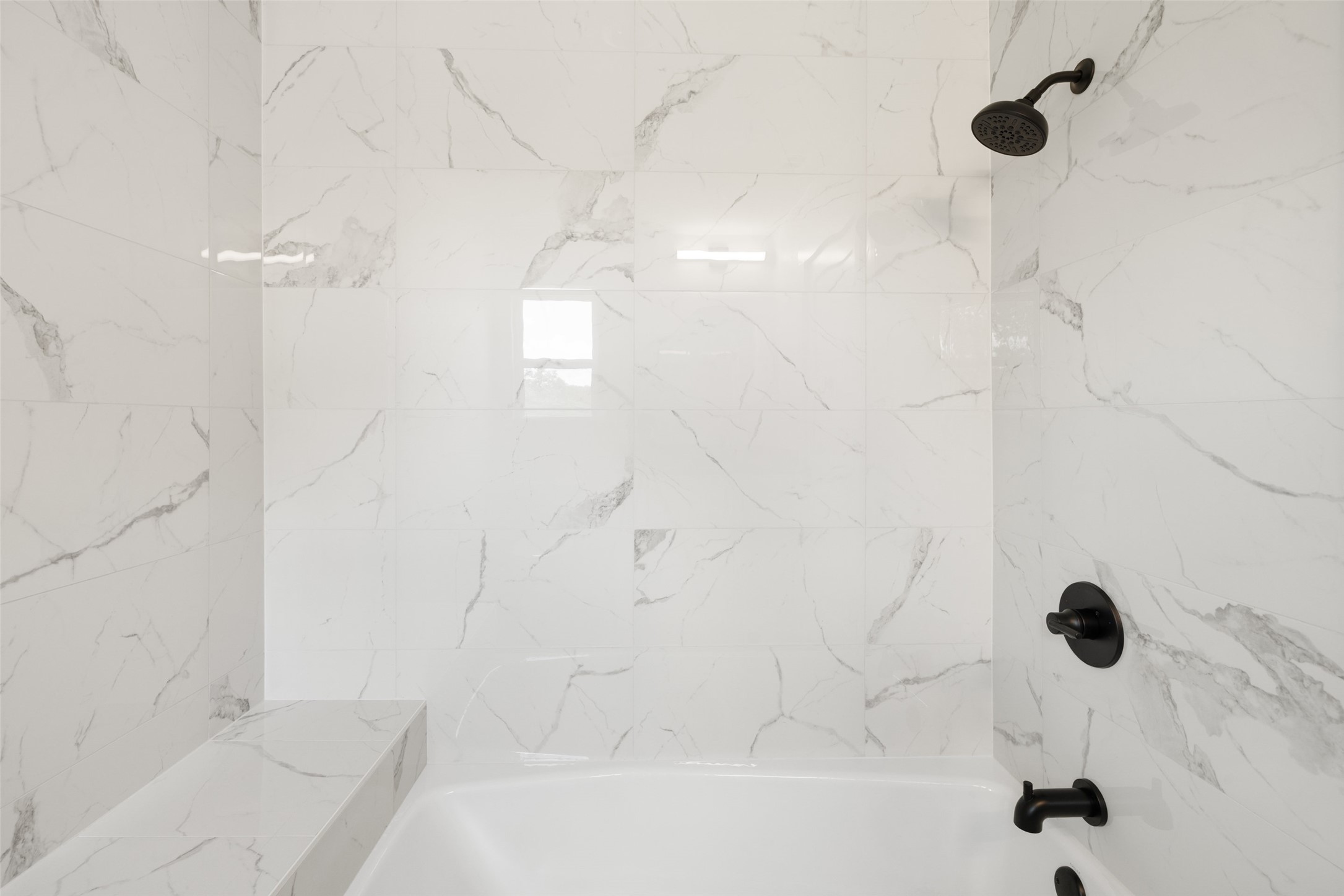 11151 Highway 71 Spicewood, TX 78669 - Photo 13 of 38 First Residence – Guest bathroom showcasing a tub/shower combo with marble-style finishes.