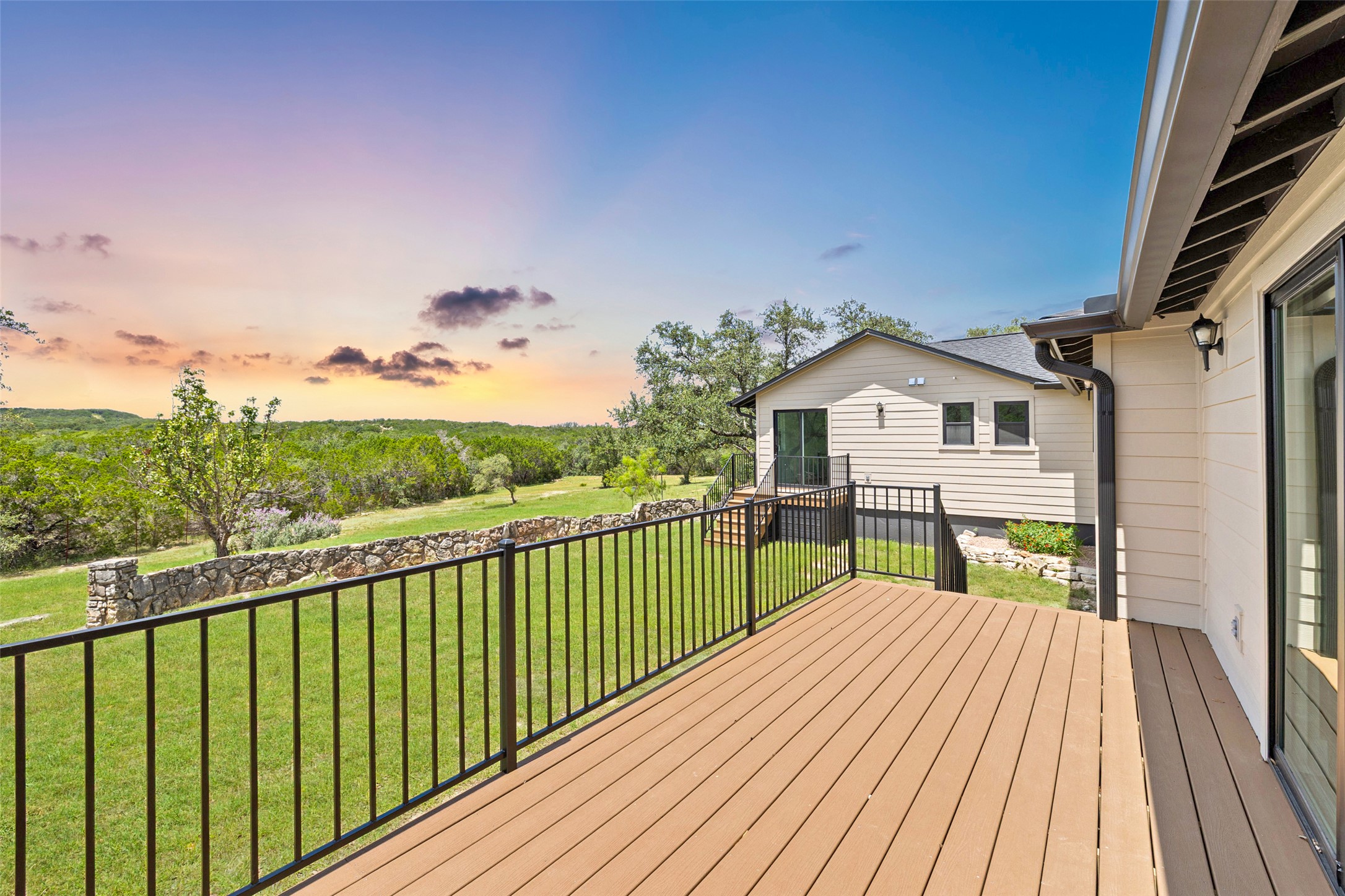 11151 Highway 71 Spicewood, TX 78669 - Photo 14 of 38 First Residence - Private deck at dusk overlooking hill country views just off the living room and kitchen.