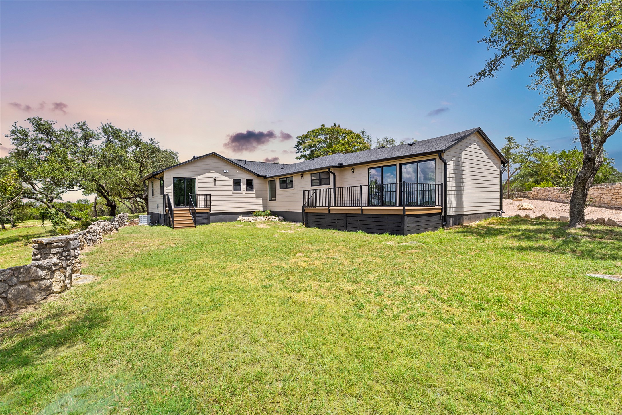 11151 Highway 71 Spicewood, TX 78669 - Photo 17 of 38 a view of a house with a big yard and large trees
