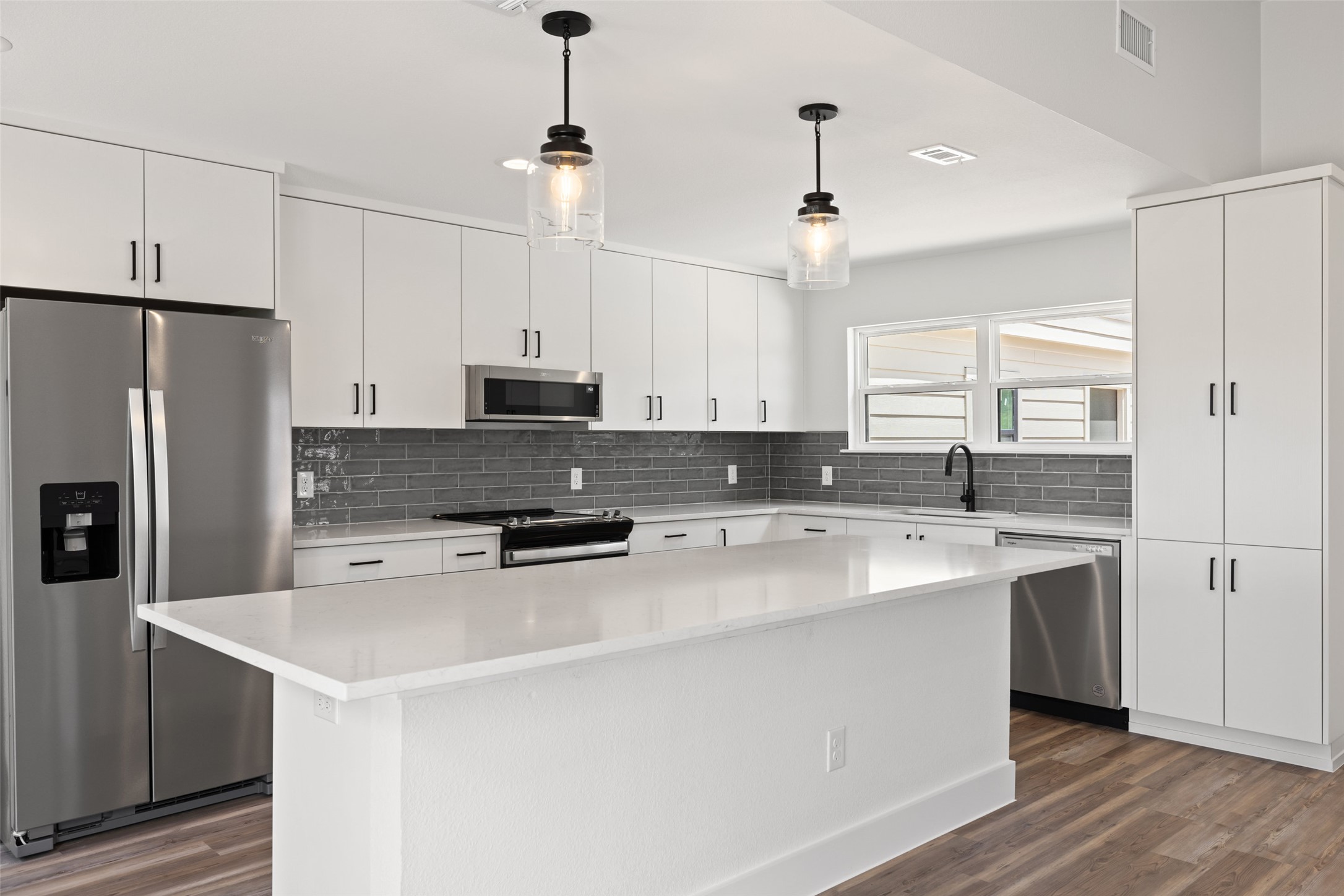 11151 Highway 71 Spicewood, TX 78669 - Photo 20 of 38 Middle Residence - This beautiful kitchen includes a new stainless steel refrigerator.