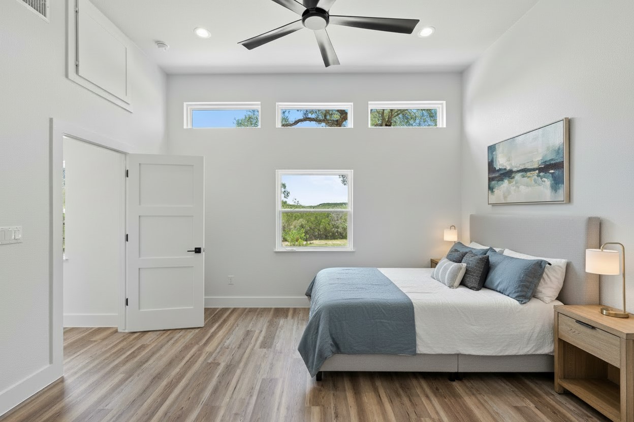 11151 Highway 71 Spicewood, TX 78669 - Photo 23 of 38 a bedroom with a bed and a painting on the wall