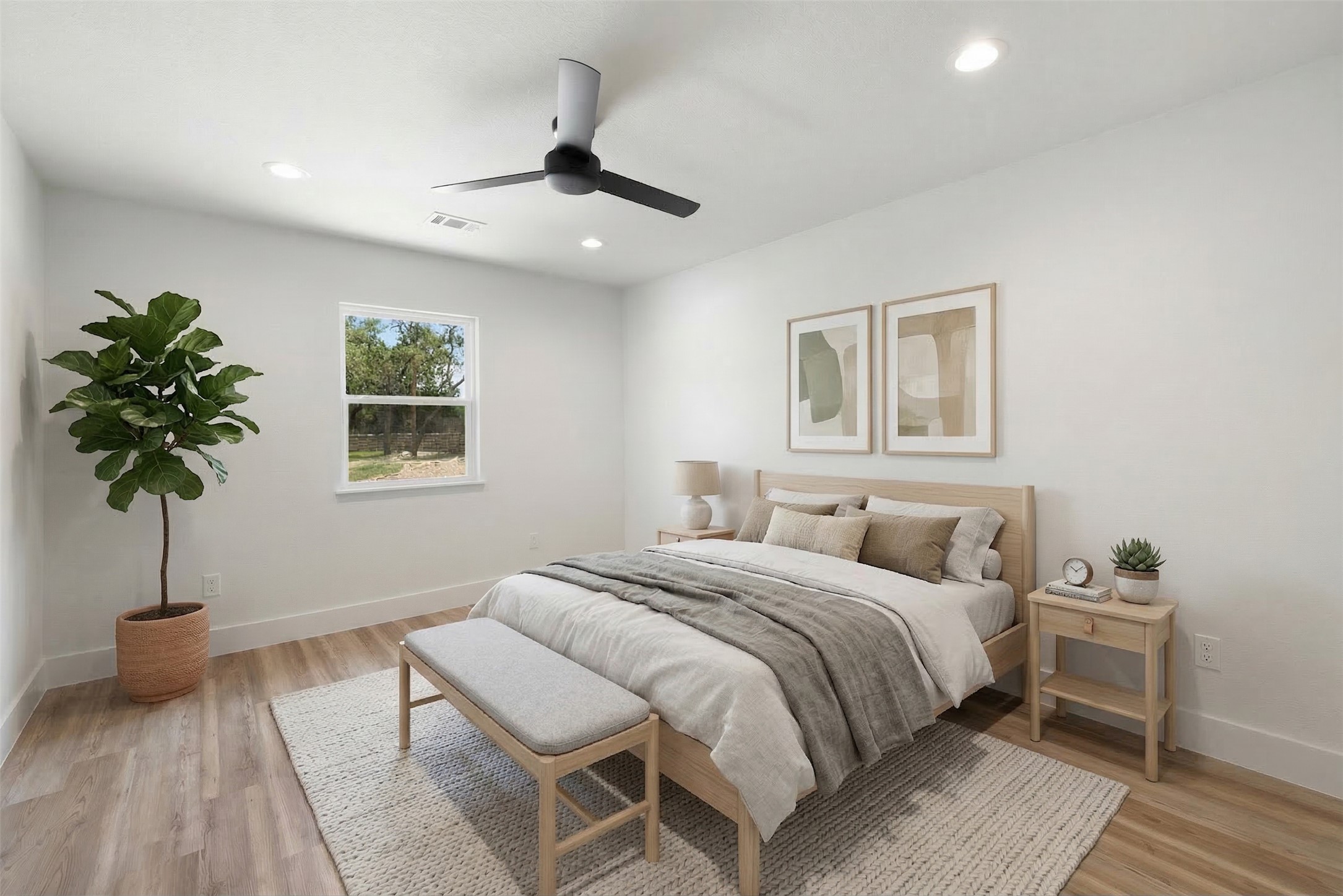 11151 Highway 71 Spicewood, TX 78669 - Photo 24 of 38 Middle Residence – Second bedroom showcasing light wood-style LVP flooring, ceiling fan, and recessed lighting. *Photo has been virtually staged.