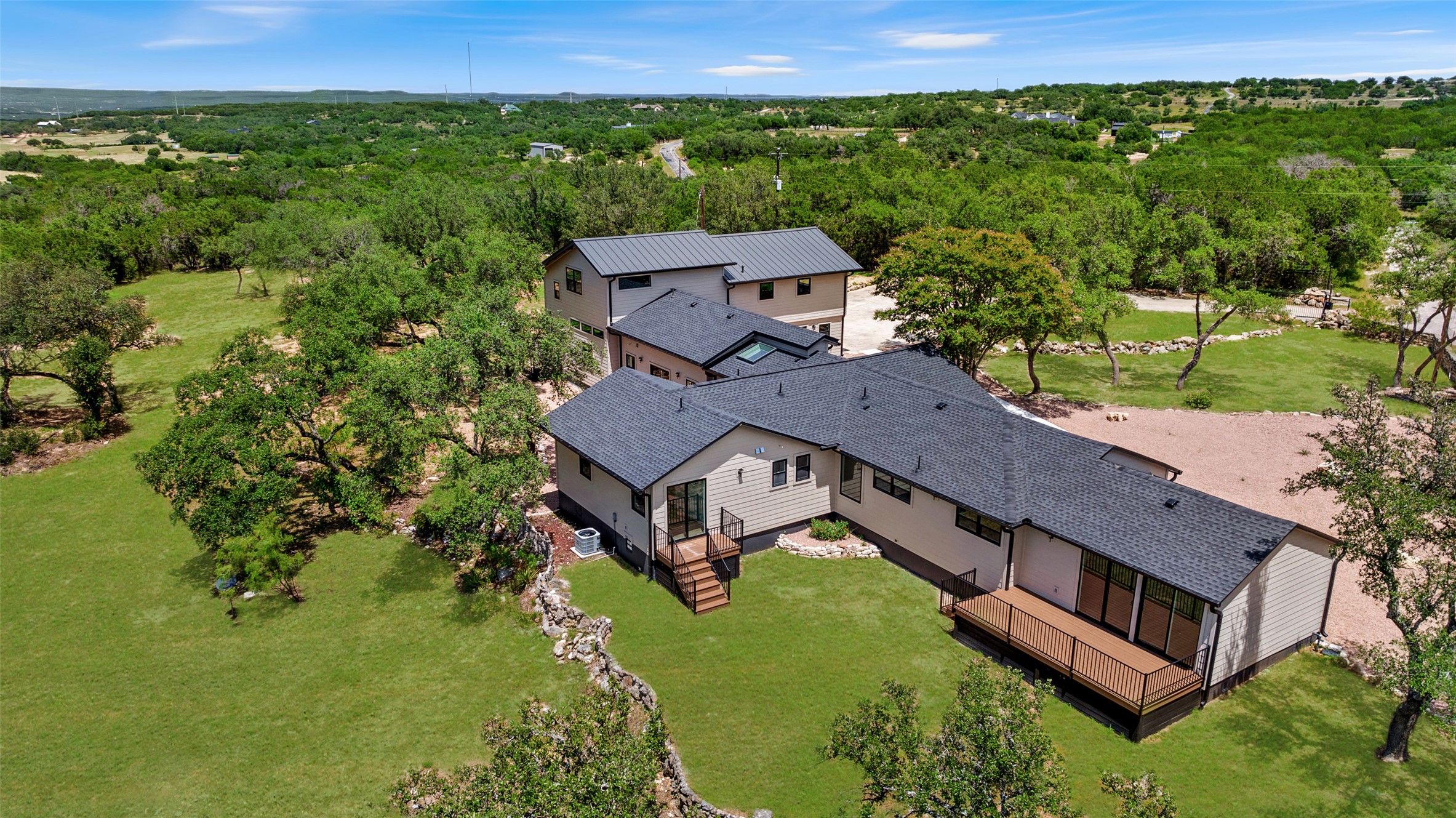 11151 Highway 71 Spicewood, TX 78669 - Photo 3 of 38 an aerial view of a house with a garden