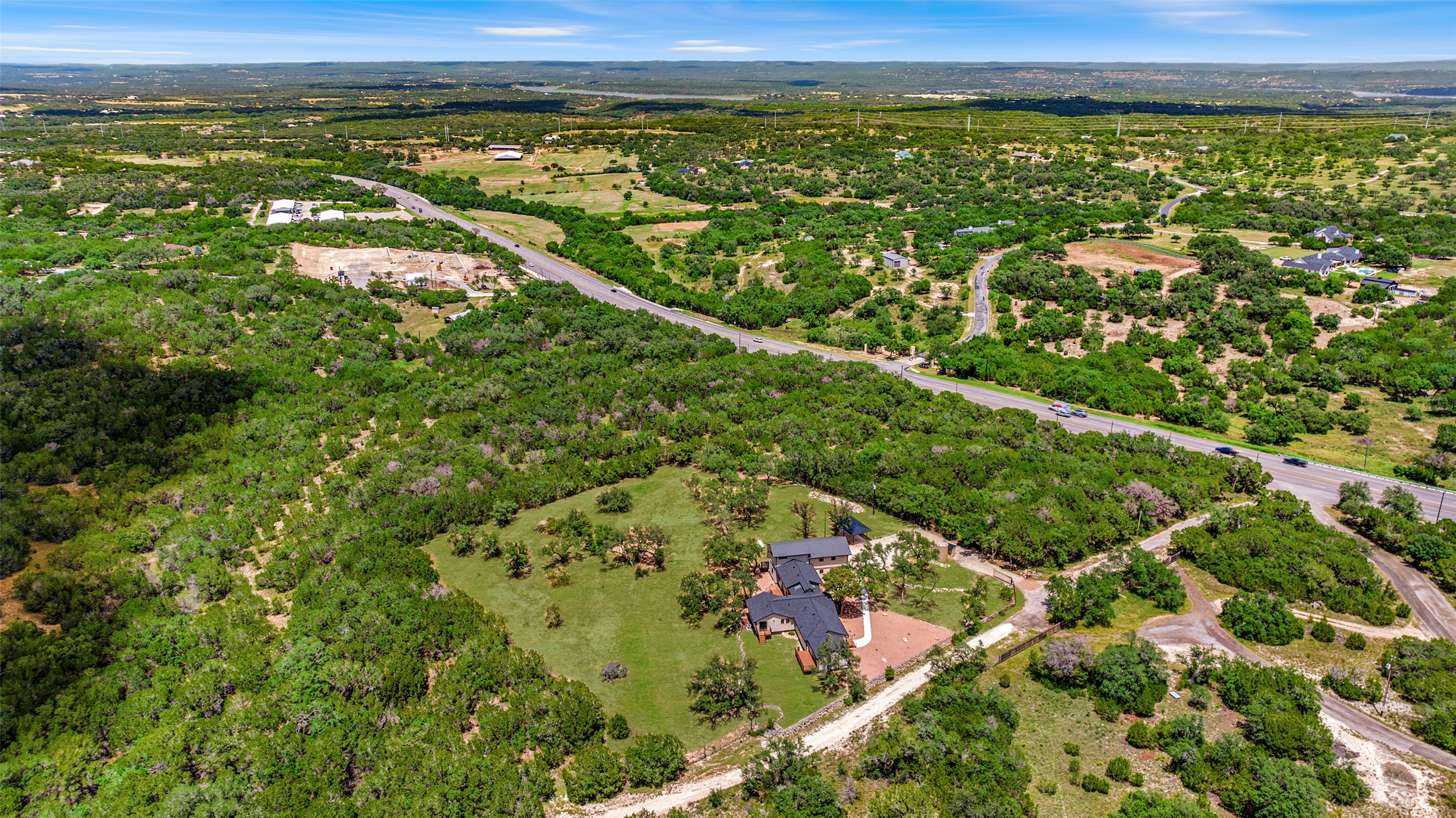 11151 Highway 71 Spicewood, TX 78669 - Photo 38 of 38 Aerial overview showcasing the property’s prime location just off State Highway 71, set back for privacy and tranquility.
