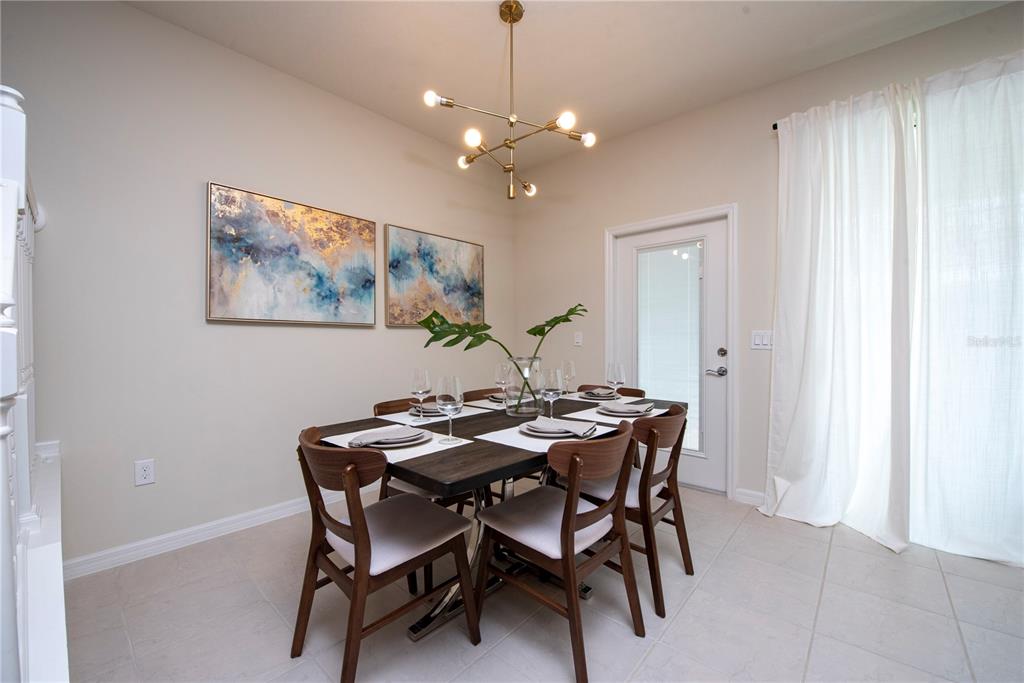126 Jetty Way Davenport, FL 33897 - Photo 11 of 52 a view of a dining room with furniture and chandelier