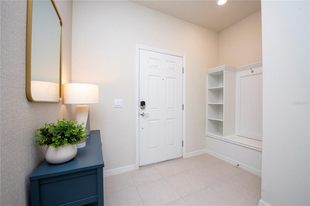 126 Jetty Way Davenport, FL 33897 - Photo 16 of 52 a room with a potted plant and wooden floor