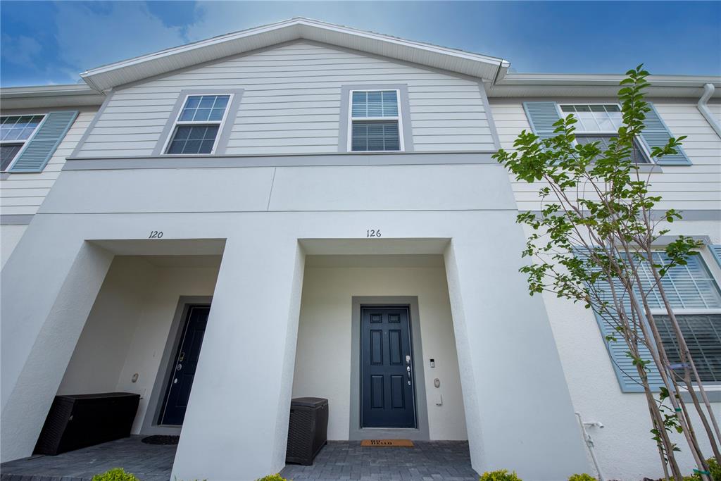 126 Jetty Way Davenport, FL 33897 - Photo 2 of 52 a potted plant sitting in front of a house