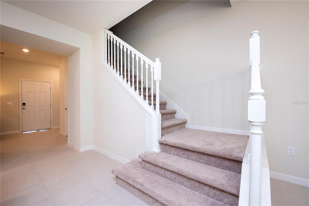 126 Jetty Way Davenport, FL 33897 - Photo 22 of 52 a view of staircase with white walls and railing