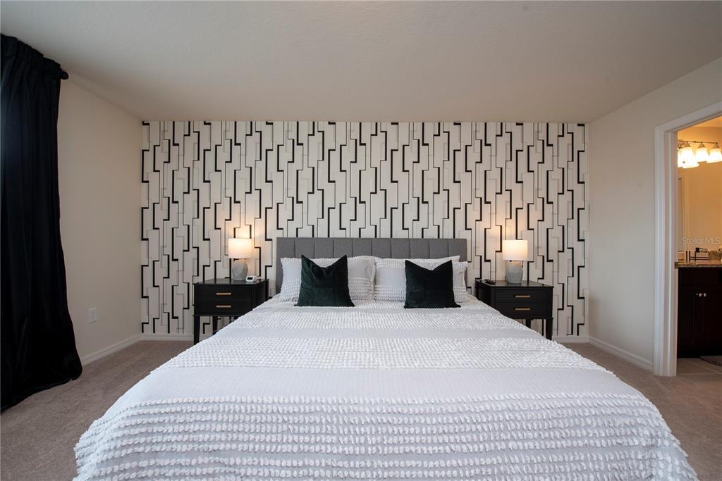 126 Jetty Way Davenport, FL 33897 - Photo 26 of 52 a bedroom with a large bed and a window