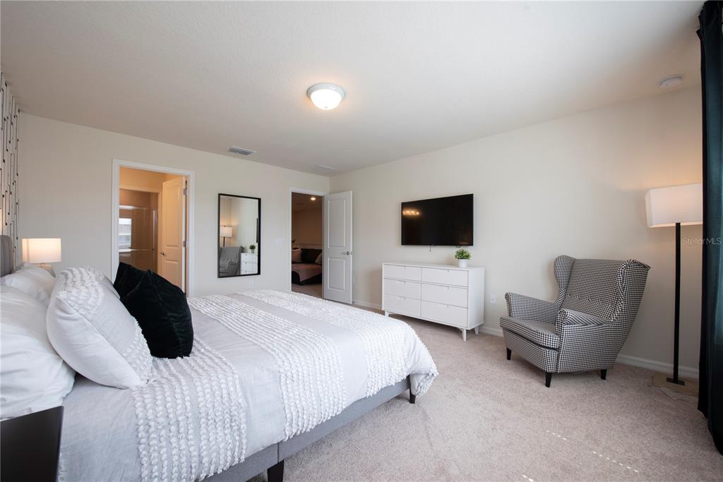 126 Jetty Way Davenport, FL 33897 - Photo 27 of 52 a bedroom with bed tv and couch