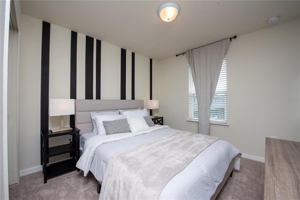 126 Jetty Way Davenport, FL 33897 - Photo 30 of 52 a bedroom with a bed and a window