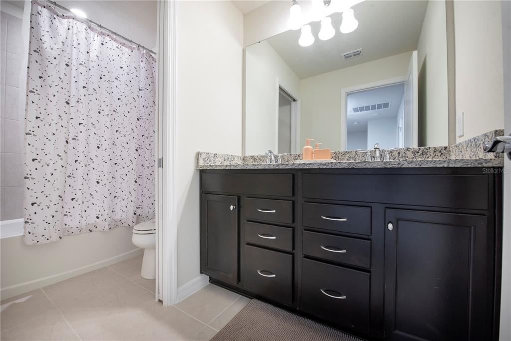 126 Jetty Way Davenport, FL 33897 - Photo 38 of 52 a bathroom with a sink a toilet and shower