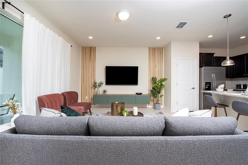 126 Jetty Way Davenport, FL 33897 - Photo 8 of 52 a living room with furniture and a flat screen tv