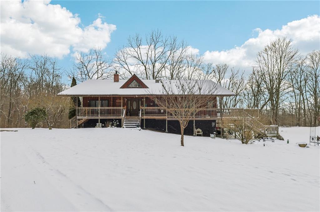 a view of a house with a wooden fence