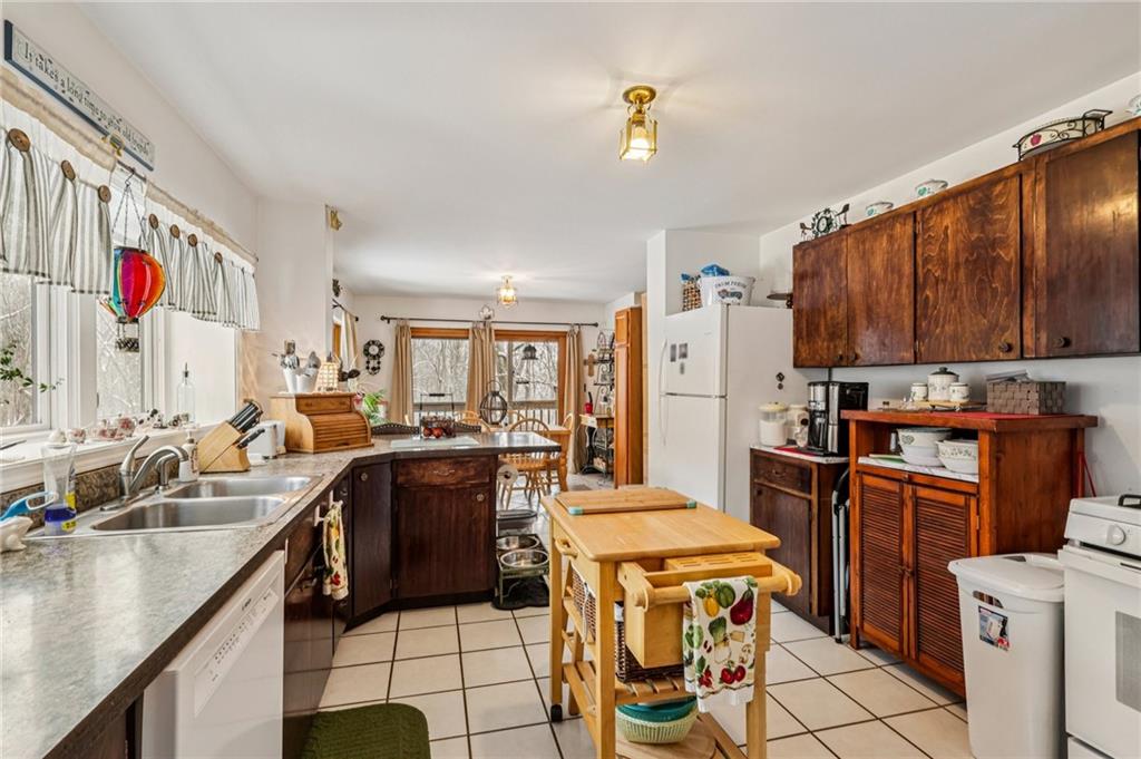 199 Anglers Rest Lane Utica, PA 16362 - Photo 17 of 49 a kitchen with a sink a stove and a refrigerator