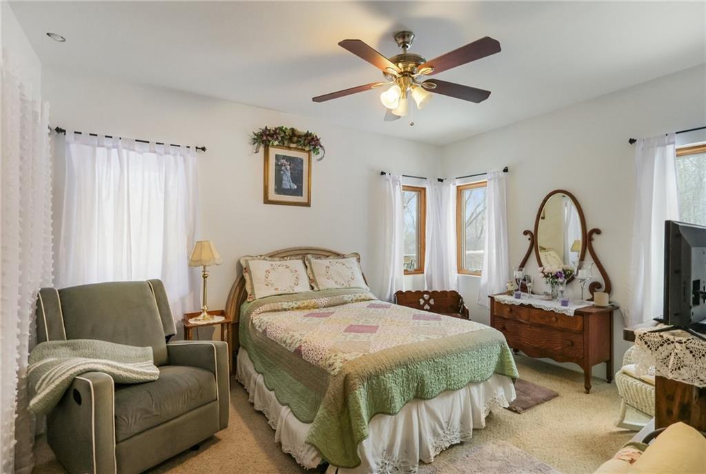 199 Anglers Rest Lane Utica, PA 16362 - Photo 23 of 49 a bedroom with a bed and a chandelier