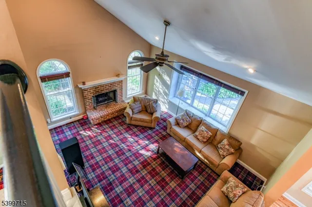 a living room with furniture a rug and a fireplace
