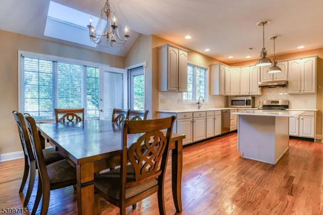 a view of a dining room and a kitchen with a table chairs