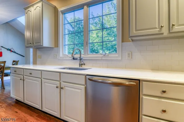 a kitchen with a sink cabinets and window