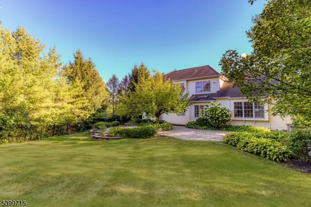 a house with swimming pool in front of it