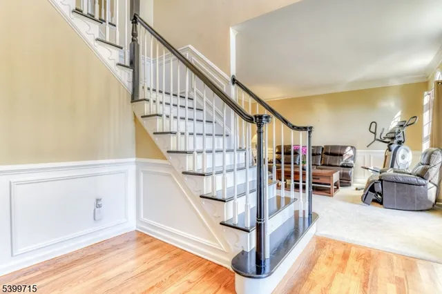 a view of entryway bedroom and hall with wooden floor