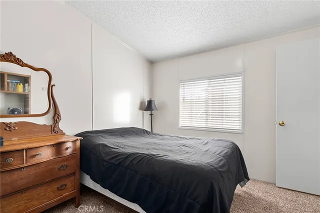 a bedroom with a bed and a mirror