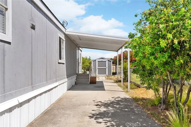 a view of a house with backyard outdoor seating and pathway