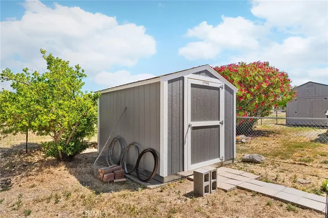 a view of a yard with plants and trees