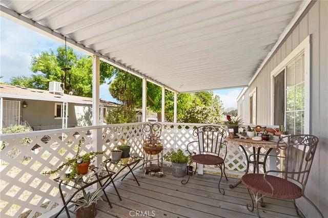 a view of a patio with table and chairs and wooden floor